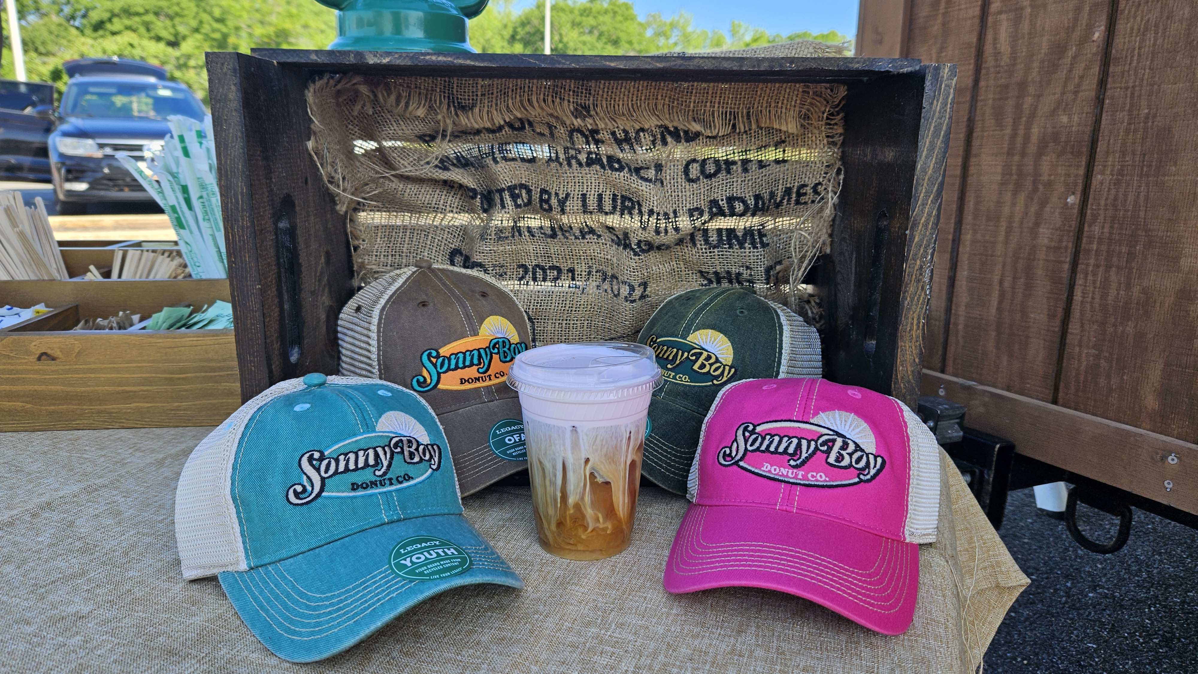 Sonny Boy branded hats on display with rustic crate backdrop